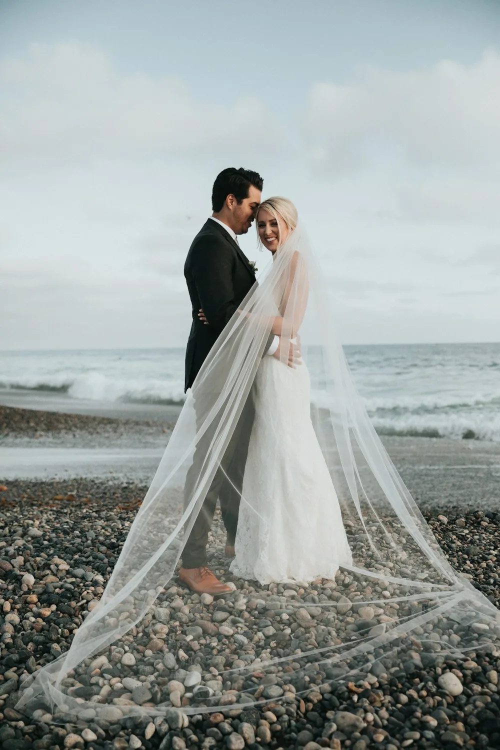 A couple celebrating their wedding by the sea